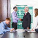 businessmen shaking hands while another is writing 80x80